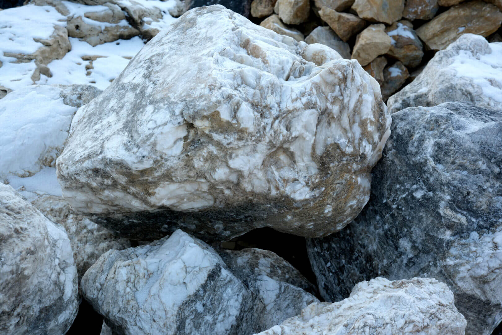 Large white and gray rocks with snow.